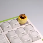Whimsical dessert artisan keycaps shown from various angles, highlighting their intricate handcrafted details and vibrant 3D miniature design.