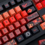 Premium artisan Diluc keycap set, featuring fiery dark red, black, and gold Genshin Impact motifs from a detailed side angle.