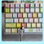 Whimsical Dopamine Keycaps Set, a PBT dye-sublimated set, displayed from a fresh angle, featuring vibrant candy colors and playful childhood dream motifs.