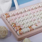 A collection of Whimsical Dream Island PBT dye-sub keycaps set, displaying their ethereal pastel islandscapes and subtle fantasy elements from multiple angles.