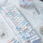 Iridescent Dreamscape glitter keycaps set of transparent PC, shown from various angles. Whimsical, ethereal, and translucent, perfect for a custom keyboard aesthetic.