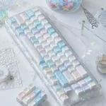 Iridescent Dreamscape glitter keycaps set crafted from transparent PC, showcasing their whimsical accents and ethereal glow from multiple delightful angles.