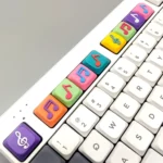 Multiple views of a Eighth Note Symbol Keycaps, showcasing vibrant translucent resin with embedded musical notes and symbols.