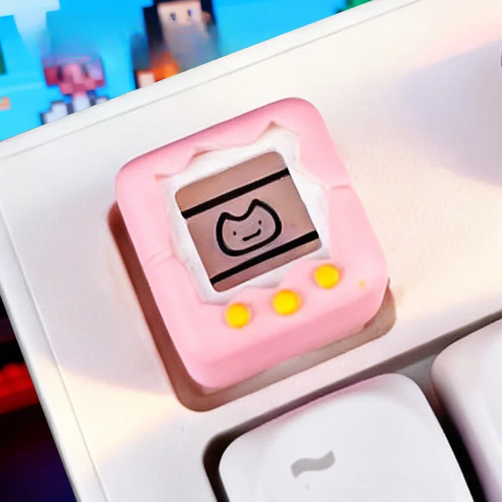 Nostalgic Electronic Pet Keycap in a playful gallery, revealing its detailed retro game console design from all angles.