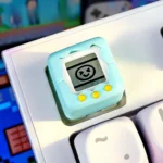 A collection of images showcasing the nostalgic electronic pet keycap from various angles, highlighting its detailed retro game console design.