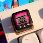 Nostalgic Electronic Pet Keycap product gallery, showcasing the detailed retro console design and playful miniature replica from various angles.