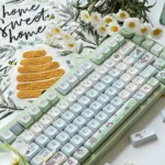 Artistic view of Spring Forest Whimsy PBT keycaps set, highlighting durable PBT and whimsical nature-inspired flora from various angles.