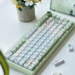 An artistic view of Spring Forest Whimsy PBT keycaps set, revealing the enchanting whimsical flora. Durable PBT for a serene, nature-inspired keyboard aesthetics.
