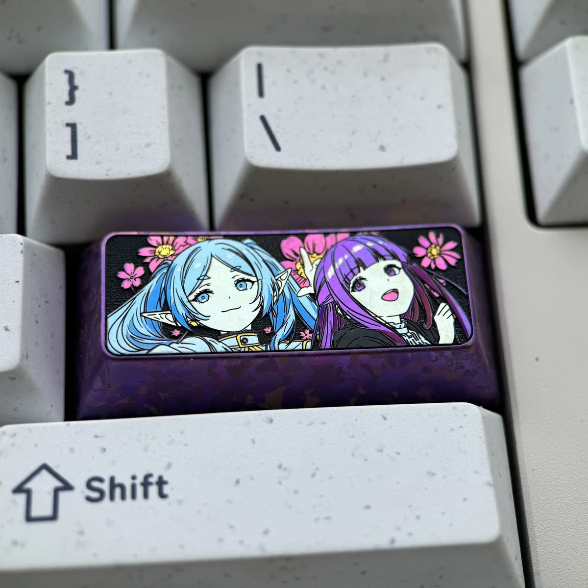 Premium Frieren & Fern titanium artisan keycap, showcasing vibrant character art and polished titanium from multiple angles. Cherry profile.