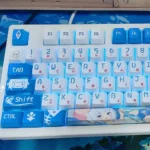 Vibrant Gawr Gura PBT keycaps set from multiple angles, showcasing cute shark and ocean-themed dye-sublimation with rich oceanic blues.