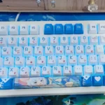 Vibrant Gawr Gura PBT keycaps set featuring cute shark-themed designs in oceanic blues, highlighting premium dye-sublimation details across the full set.
