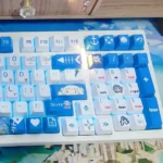 Gawr Gura PBT keycap set from various angles, showcasing vibrant shark designs and playful oceanic blues. Premium dye-sublimation for lasting fun.
