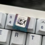 Artisan crafted Gengar Ice Crystal Titanium Pokemon ESC keycap, shown from different angles, revealing its vibrant iridescent finish and premium alloy design.