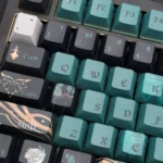Premium Alhaitham Genshin keycaps set, shown from multiple angles, featuring elegant green and gold Dendro scholar designs and intricate detailing.