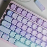 Artistic close-up of vibrant Geometric Gradient Keycaps Set, revealing the serene pink-blue PBT material and crisp geometric patterns for a modern desktop.