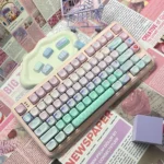 Vibrant PBT dye-sublimated geometric gradient keycaps set, showcasing serene pink-blue hues and artistic patterns for a modern desktop.