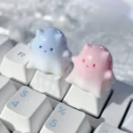 Artistic gallery showcasing the whimsical Ghost Cat Keycap's hand-painted resin, translucent pastel hues, and unique ethereal design from multiple angles.