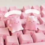 Whimsical hand-painted resin ghost cat keycap, showcasing a unique gradient pink design with translucent, ethereal charm.
