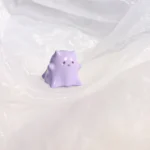 Hand-painted resin Whimsical Ghost Cat Keycap featuring a unique taro-purple head and translucent body, an ethereal piece of art.