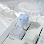 Unique hand-painted resin ghost cat keycap with a whimsical blue-white gradient, embodying a cute and ethereal art style.