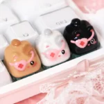 Gallery view of handcrafted 3D cat keycaps, showcasing unique sculptural, playfully stacked felines from various angles for whimsical charm.