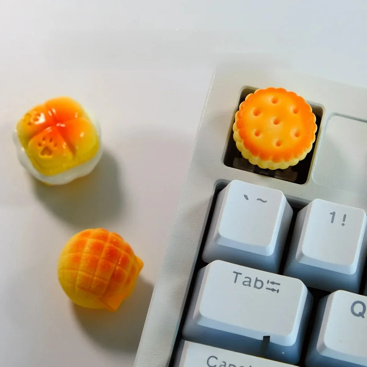 Handcrafted artisan keycaps of whimsical baked desserts, seen from various angles. These delectable miniature treats add premium culinary art to keyboard.