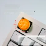 Experience a handcrafted artisan keycap, meticulously detailed as a realistic caramel biscuit. This whimsical baked dessert adds a premium, sweet touch.