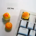 Delectable handcrafted artisan keycaps showcasing whimsical miniature baked desserts, a sweet treat for any keyboard.