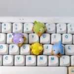 Whimsical handcrafted 3D artisan Parrot Hugging Stump keycap, featuring a vibrant parrot perched on a wooden stump with a delicate peony, showcased from a captivating design.