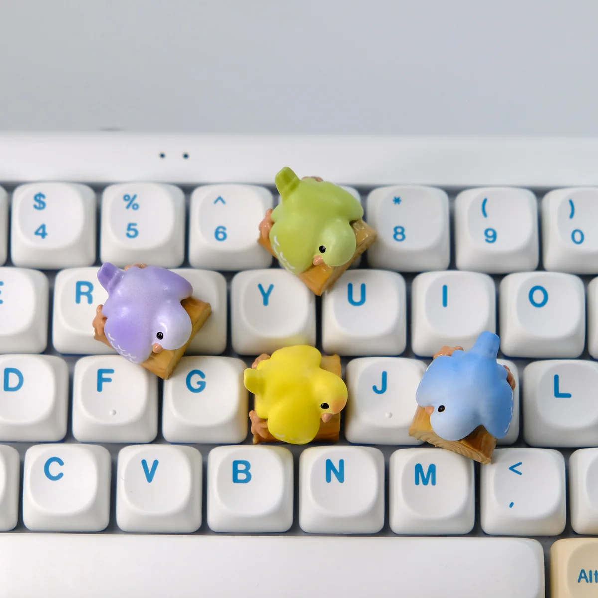 Whimsical handcrafted 3D artisan Parrot Hugging Stump keycap, featuring a vibrant parrot perched on a wooden stump with a delicate peony, showcased from a captivating design.