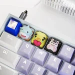Vibrant handcrafted resin animal artisan keycaps, showcasing whimsical designs and intricate details from multiple artistic angles.