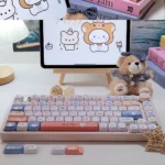 A collection of Hello bear emoji PBT keycaps set in vibrant white, showcasing their durable design from various playful angles