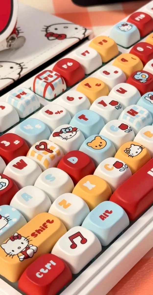 Playful Hello KittA collection of Hello Kitty MOA profile keycaps set from different angles, highlighting the vibrant character art and smooth, ergonomic design.y MOA profile keycap set photos, displaying iconic character art, smooth pastel aesthetic, and its unique shape from different angles.