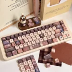 Exclusive Hello Kitty Mont Blanc dessert keycaps set, displaying warm creamy browns, whites, playful Hello Kitty motifs, and elegant dessert designs.