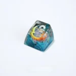 Exclusive Hollow Knight Silksong Lace ESC keycap, revealing its intricate translucent art and ethereal glow from various perspectives.