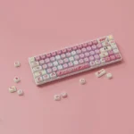 Playful Kirby Keycaps set crafted from durable PBT, featuring iconic whimsical designs and an ergonomic MOA profile in vibrant pastel colors.
