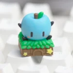 Close-up views of the playful handcrafted Stardew Valley Junimo ESC keycap, highlighting its vibrant resin and intricate pixel-art details.