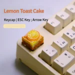 Whimsical handcrafted lemon toast cake artisan keycap, a charming miniature food art piece for keyboards.