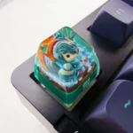 Multiple angles of the handcrafted Hwei LoL artisan keycap, showcasing its vibrant, translucent resin design and meticulous character sculpting.