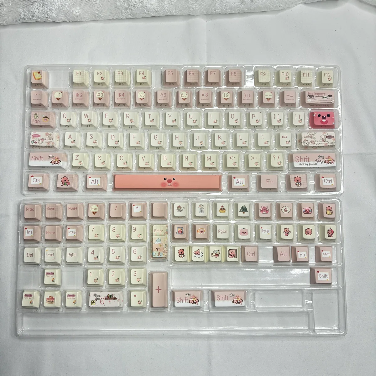 Playful Loopy Series PBT keycaps set displayed from various angles, highlighting their vibrant, whimsical cartoon designs and ergonomic profile.