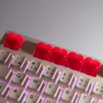 Side view of the vibrant 3D red heart keycap, revealing its perfectly sculpted form and translucent material for brilliant backlighting.