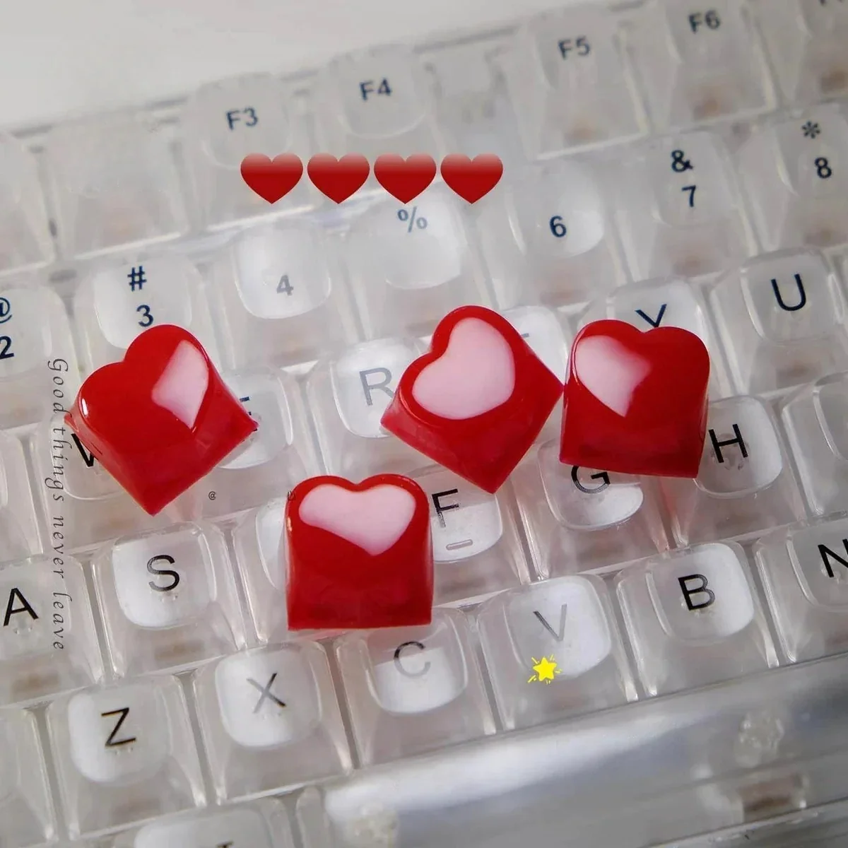 A gallery of radiant 3D red heart keycaps, showcasing their luminous sculpted design and smooth finish from various angles, perfect for backlit keyboard.