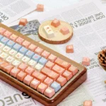 Close-up of the charming Maillard Bear PBT dye-sub keycap set, showcasing cute bear illustrations in warm caramel and brown tones from various angles.
