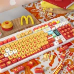 McDonald's Keycaps MOA PBT Fun Set, featuring vibrant red, yellow, and white iconic fast-food designs shown from various angles. Enjoy premium PBT quality material.