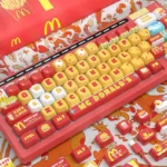 Vibrant McDonald's Keycaps set showcasing iconic red, yellow, and white colors with playful fast-food designs on premium MOA PBT keycaps.