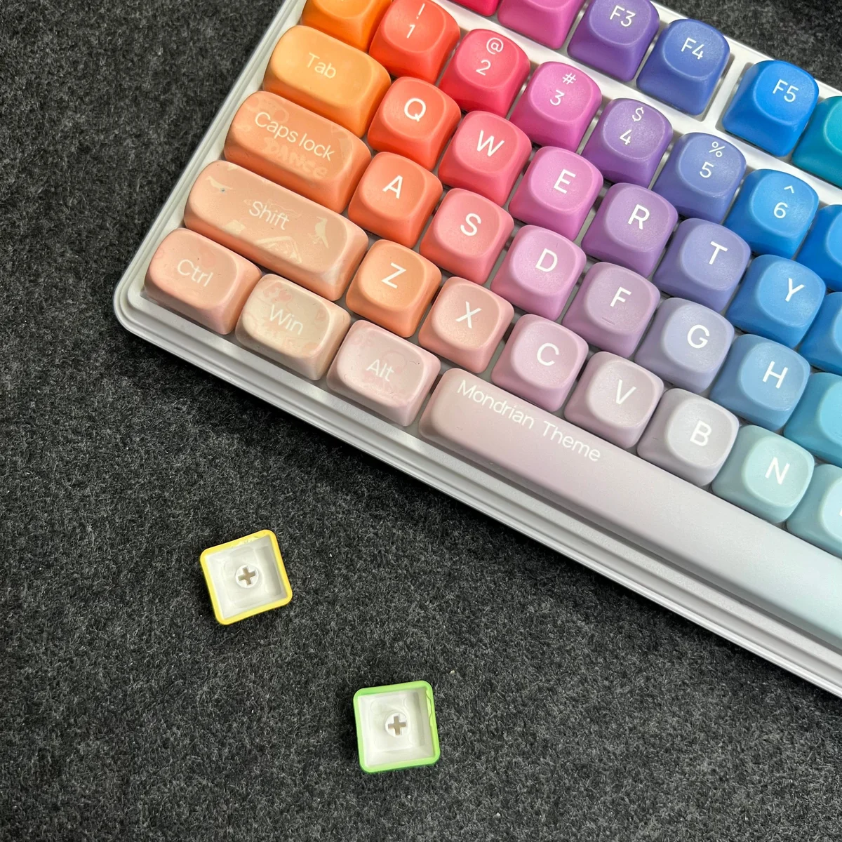 A dynamic angle of the Mondrian Themed MOA Keycap Set, showcasing their brilliant gradient hues and smooth texture for an energetic desk.