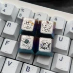 Close-up of a premium Characters Titanium Pokemon artisan keycap, showcasing its iridescent finish and intricate sculptural details from multiple angles.