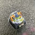 Handcrafted Naruto artisan resin keycap. Vibrant, intricate Seven-Tails sculpture from a detailed angle. Artistic Naruto keycap.