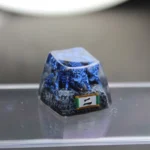 Handcrafted Naruto Matatabi artisan keycap, close-up showing the fiery mythical feline with glowing blue flames and intricate resin sculpture details.