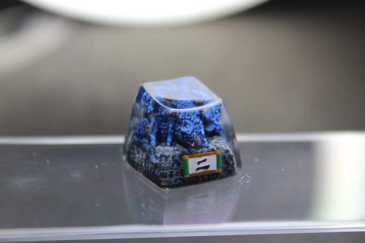 Handcrafted Naruto Matatabi artisan keycap, close-up showing the fiery mythical feline with glowing blue flames and intricate resin sculpture details.
